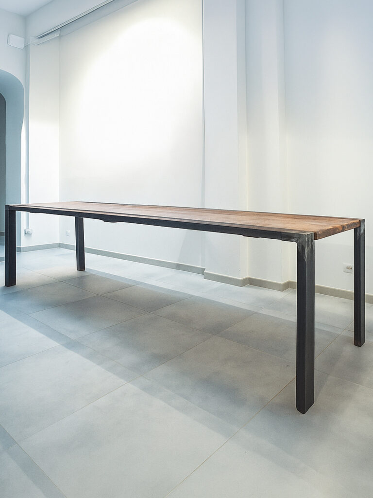 tavolo artigianale con piano in legno e gambe in ferro spazzolato in stile industriale minimale